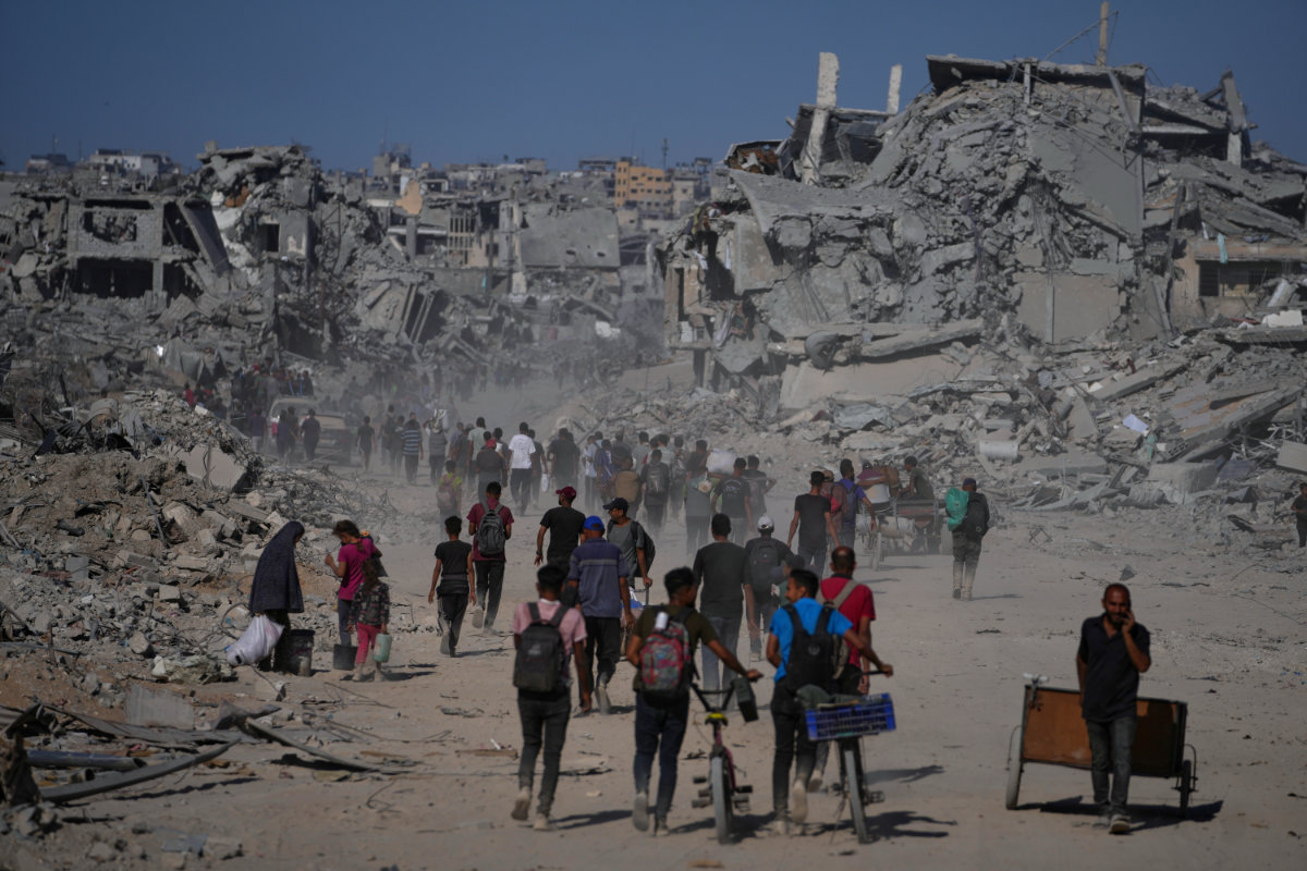 Displaced Palestinians walk past destroyed buildings as they return to their homes in the Zeitoun neighborhood of Gaza City on Oct. 10, 2025, after Israel and Hamas agreed on a ceasefire and the release of remaining hostages. (AP)