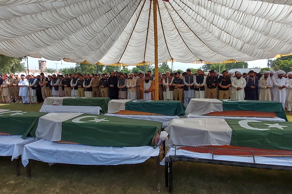 Officials and others attend funeral prayers of police officers, who were killed when gunmen attacked a police training center, in Dera Ismail Khan in northwestern Pakistan on Oct. 11, 2025. (AP)