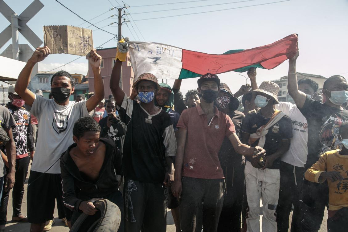 Protesters hold a Madagascar flag amid a strike calling for constitutional reforms and the resignation of President Andry Rajoelina in Antananarivo, on Oct. 9, 2025. (AFP)