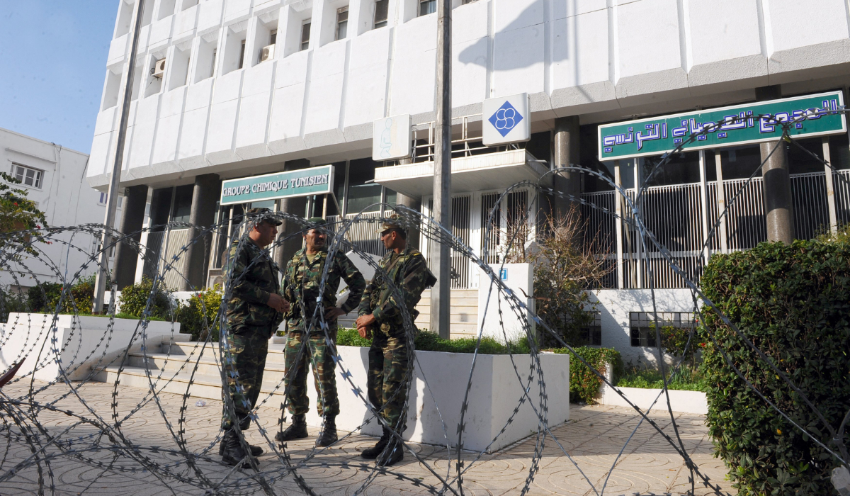 Tunisian soldiers stand guard in front of the headquarters of the Tunisian Chemical Group in Tunis on November 30, 2011. (AFP)