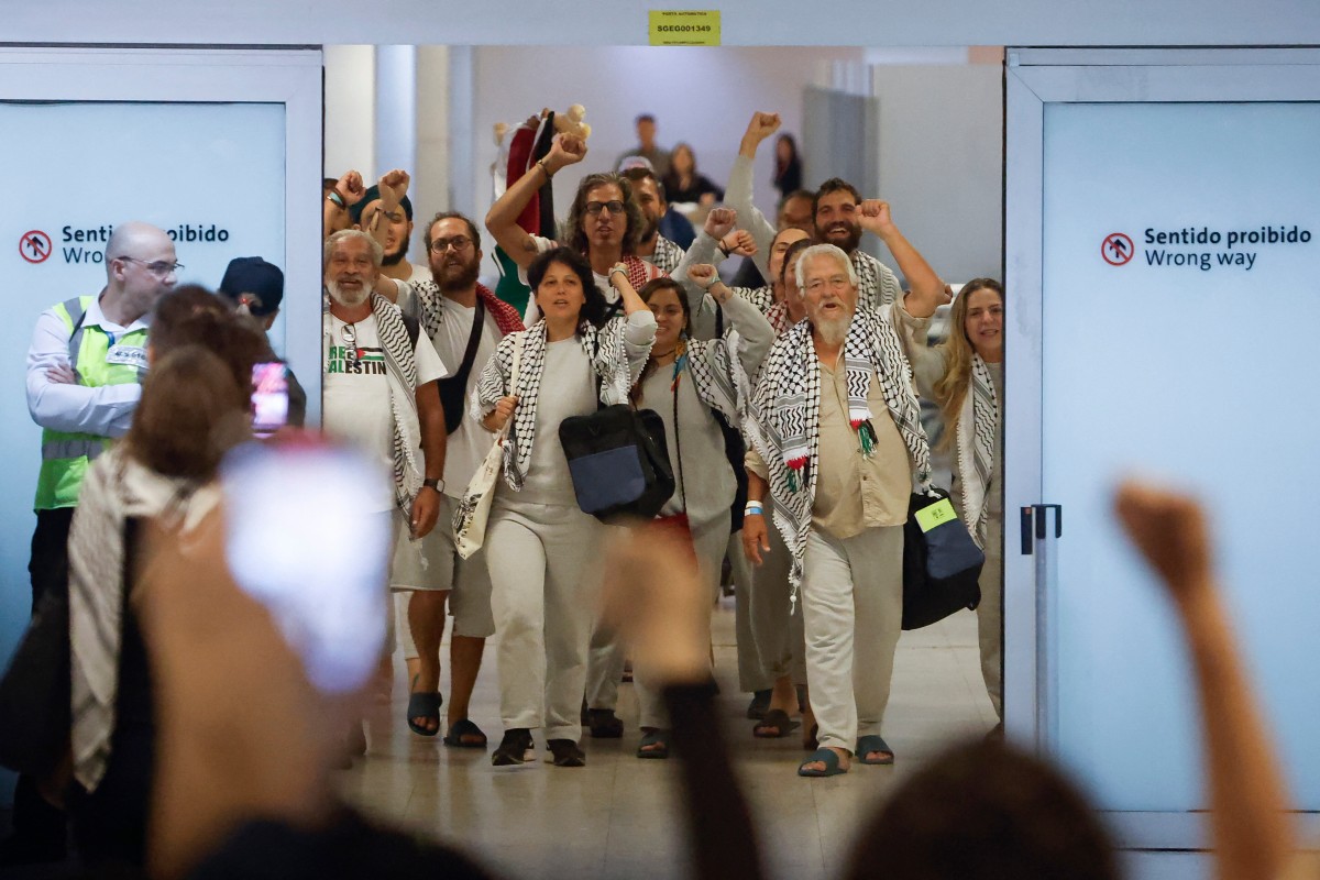 Brazilian activists, members of the Global Sumud flotilla, celebrate upon arrival at Guarulhos International Airport in Sao Paulo, Brazil, Oct. 9, 2025. (AFP)