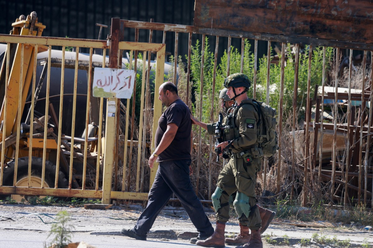 Israeli soldiers arrest a man during a search raid following the reported explosion of an Israeli military vehicle near a checkpoint west of Tulkarem in the occupied West Bank, Sept. 11, 2025. (AFP)