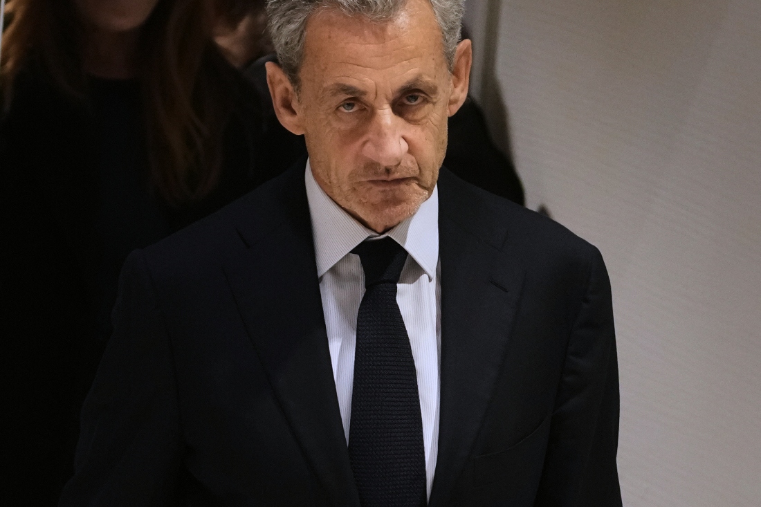 Former French President Nicolas Sarkozy leaves after a Paris court sentenced him to 5 years after finding him guilty of criminal conspiracy in an alleged scheme to finance his 2007 campaign with funds from Libya. (AP)