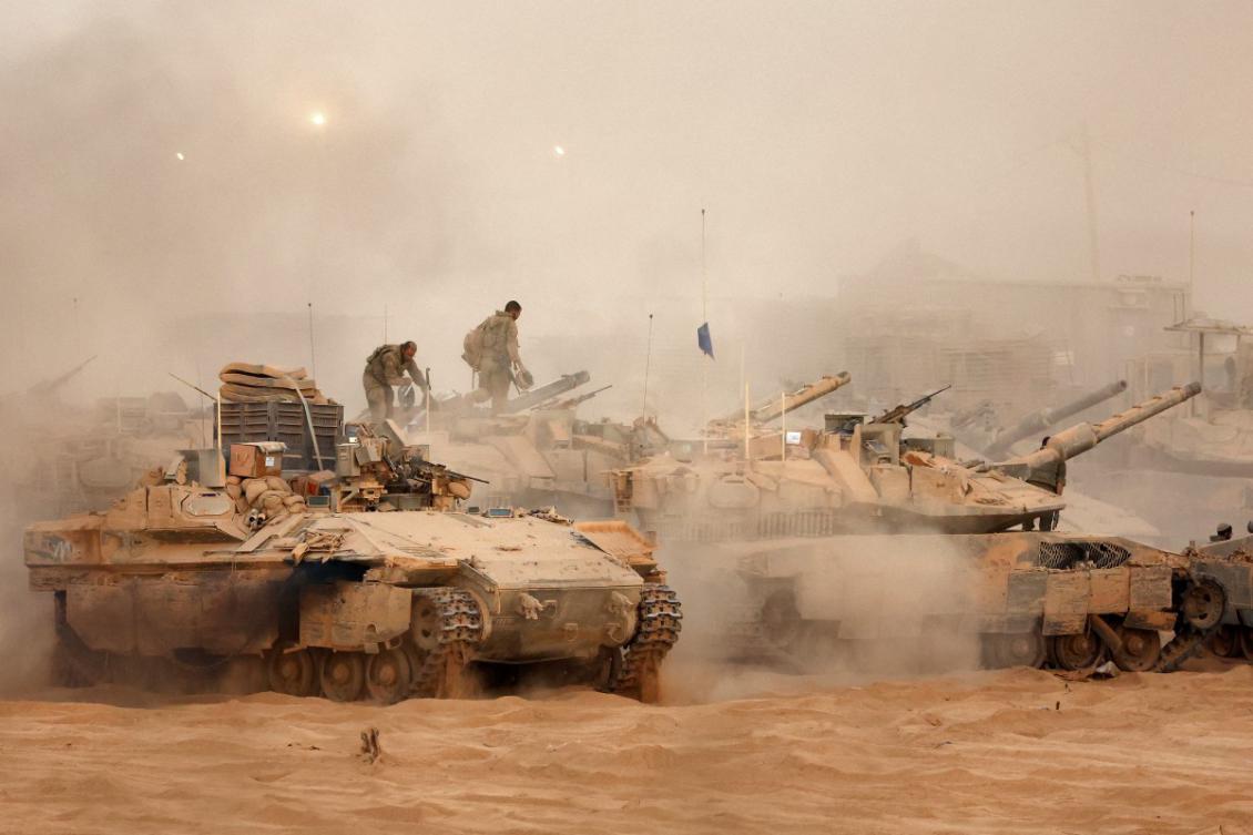 An Israeli army infantry-fighting vehicle (IFVs) deploys next to main battle tanks at a position along the Israel-Gaza border fence on October 10, 2025.(FIle/AFP)