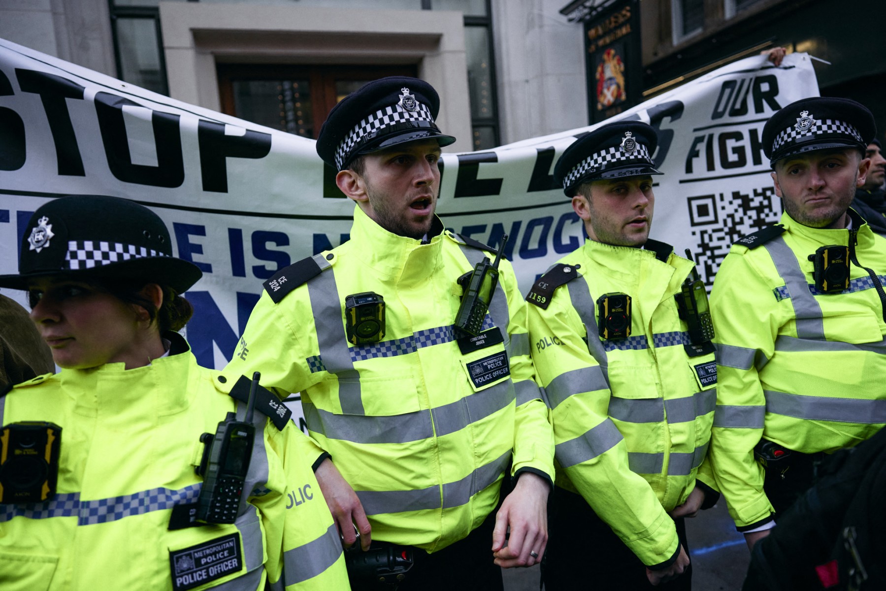 Police officers intervene as a pro Israel banner is held during a combined March for Global Climate Justice, organized by the Cimate Justice Coalition, in London on November 16, 2024, "to demand the UK government ends our reliance on fossil fuels, pays up for climate finance – and ends its complicity in Israel’s escalating genocidal violence". (File/AFP)