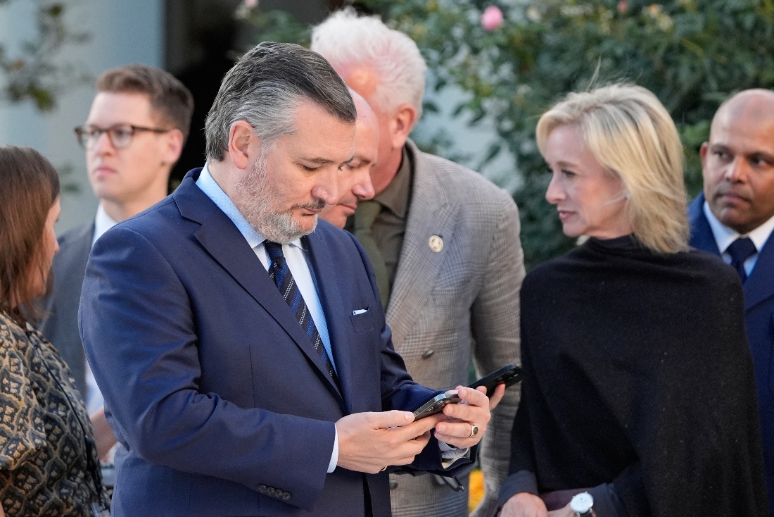 Senator Ted Cruz checks his phone after President Donald Trump posthumously awarded the Presidential Medal of Freedom to Charlie Kirk in the Rose Garden of the White House in Washington, US. (AP)