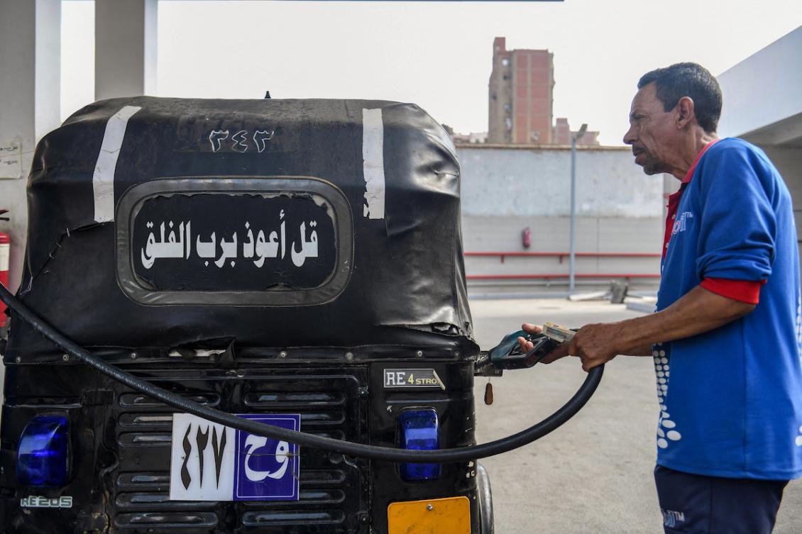 A worker fills the tank of a three-wheeled vehicle at a petrol station in Cairo on July 26, 2024. (FILE/AFP)