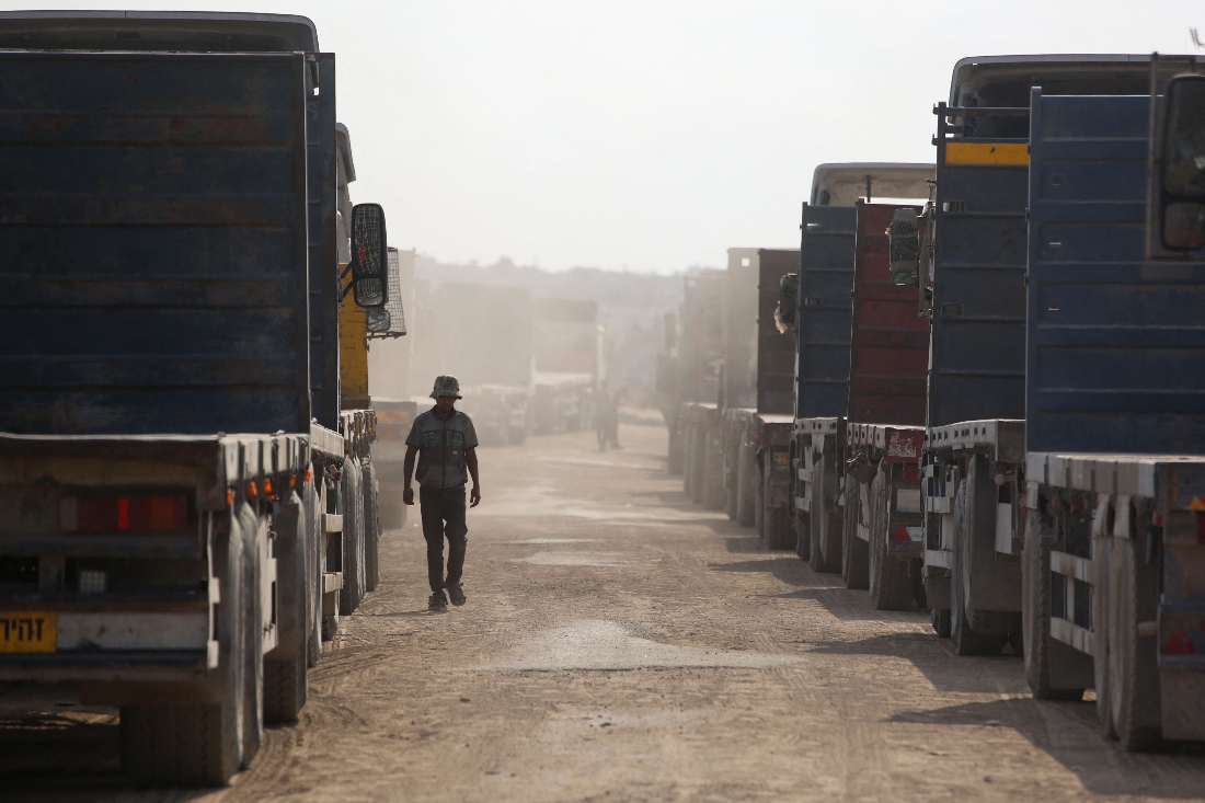 Trucks carrying aid provided by the World Food Programme (WFP) wait at the Kissufim crossing, located east of Deir el-Balah in the central Gaza Strip. (AFP)
