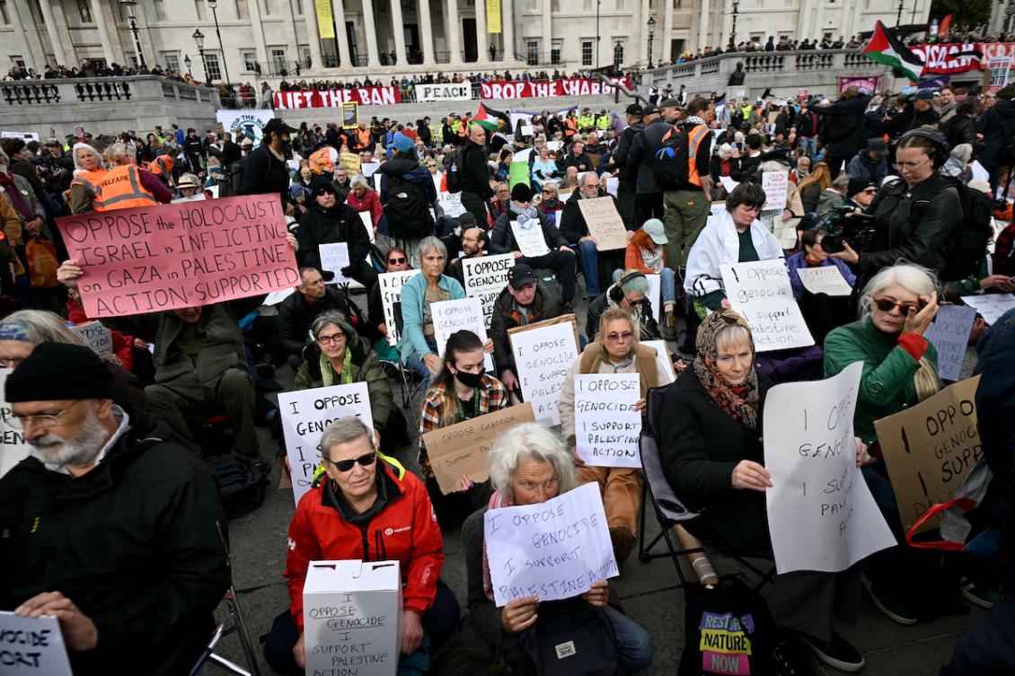 Protestors hold placards at a "Lift The Ban" demonstration in support of the proscribed group Palestine Action, calling for the recently imposed ban to be lifted, in Trafalgar Square, central London, on October 4, 2025. (FILE/AFP)