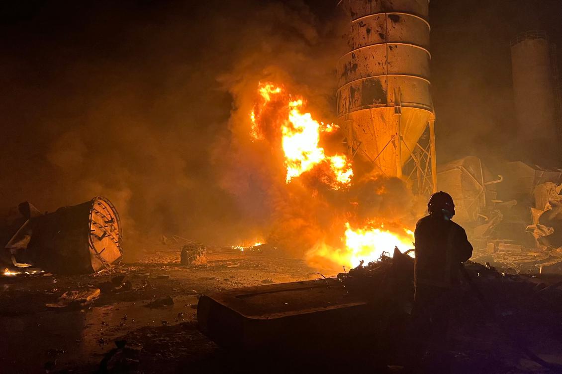A firefighter douses the flames of a fire that took over a cement manufacturing complex following a series of Israeli airstrikes, in the village of Ansar, near Doueir, southern Lebanon, on Oct. 16, 2025. (AFP)
