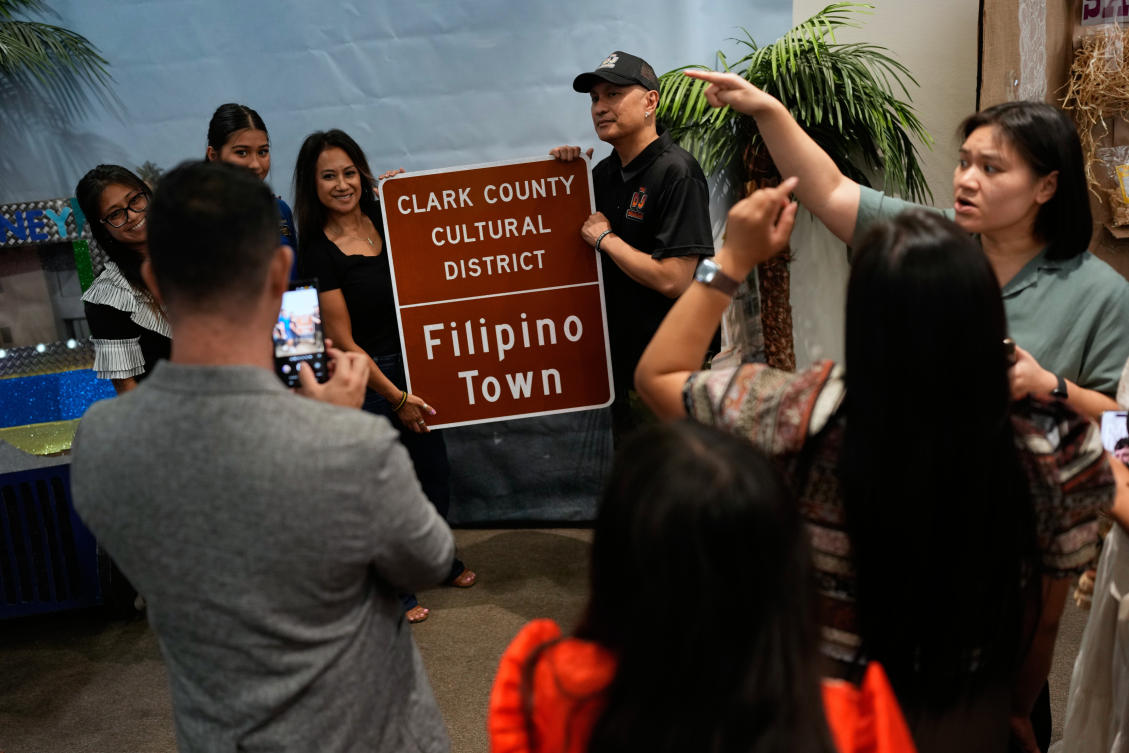People pose around a sign at a celebration for the designation of Filipino Town as a Clark County Cultural District in Las Vegas on Oct. 9, 2025. Filipinos are the largest Asian group in metro Las Vegas with over 200,000. (AP)