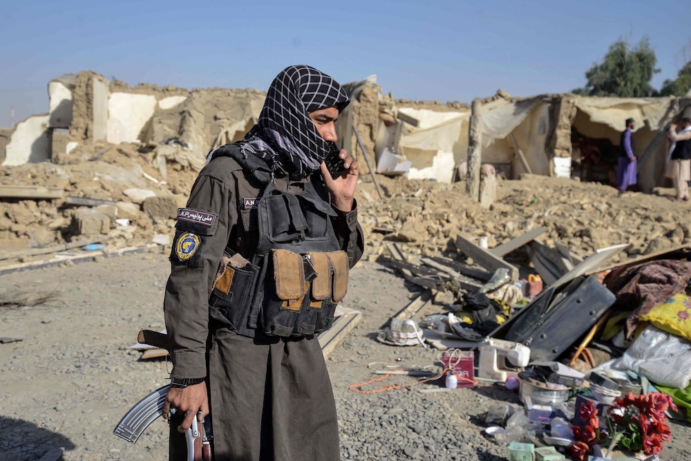 Above, a Taliban security member stands near a damaged house in the Spin Boldak district of Kandahar province on Oct. 16, 2025. (AFP)