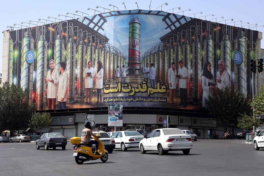 Above, a billboard at the Enqelab Square in Tehra displays pictures of nuclear scientists, centrifuges and a sentence reading in Farsi: ‘Science is the power’ on Aug. 29, 2025. (AFP)