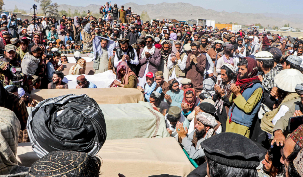 Afghan relatives and mourners surround coffins of victims, killed in aerial strikes by Pakistan, during a funeral ceremony at a cemetery in the Urgun district of Paktika province on October 18, 2025. (AFP)