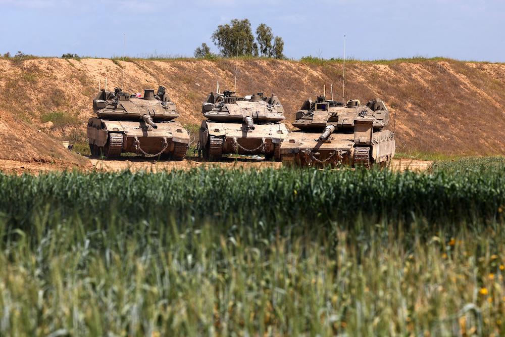 Above, Israeli military tanks are positioned along Israel’s southern border with the northern Gaza Strip. (AFP file photo)