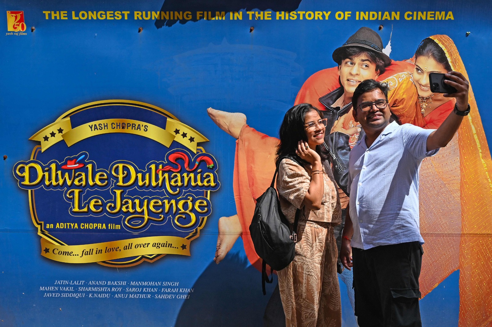 In this picture taken on October 11, 2025, moviegoers take a selfie ahead of the screening of the popular Bollywood Hindi film ‘Dilwale Dulhania Le Jayenge’ (The brave hearted will take the bride away) at Maratha Mandir theater in Mumbai. India’s longest running film celebrates its 30-year run in a cinema on Monday, a Bollywood romance so beloved that fans simply know it by its acronym, DDLJ. (AFP)