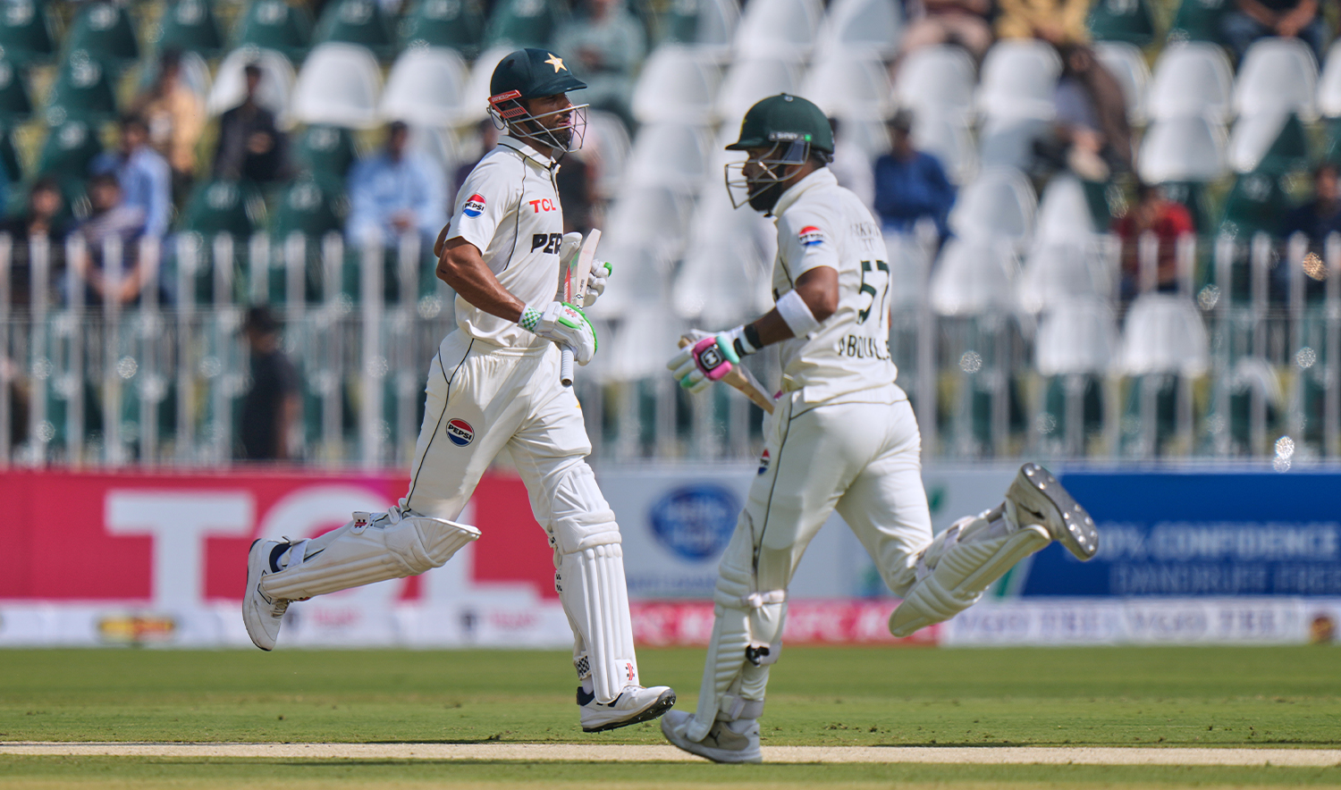 Pakistan's Shan Masood, left, Abdullah Shafique run between the wickets during the first day of the second test cricket match between Pakistan and South Africa, at the Rawalpindi Cricket Stadium, in Rawalpindi, Pakistan, on Oct. 20, 2025. (AP)
