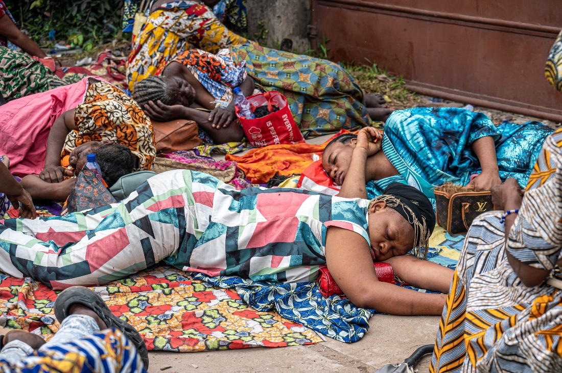 Victims of the April floods in the Tshangu district rest during their demonstration in front of the residence of Democratic Republic of the Congo's President Felix Tshisekedi, in Kinshasa. (AFP)