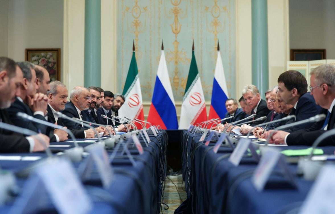 In this pool photograph distributed by the Russian state agency Sputnik, Russia's President Vladimir Putin (C-R) and Iran's President Masoud Pezeshkian (C-L) sit with their delegations during a meeting on the sidelines of the Shanghai Cooperation Organisation (SCO) Summit in Tianjin on September 1, 2025. (File/AFP)