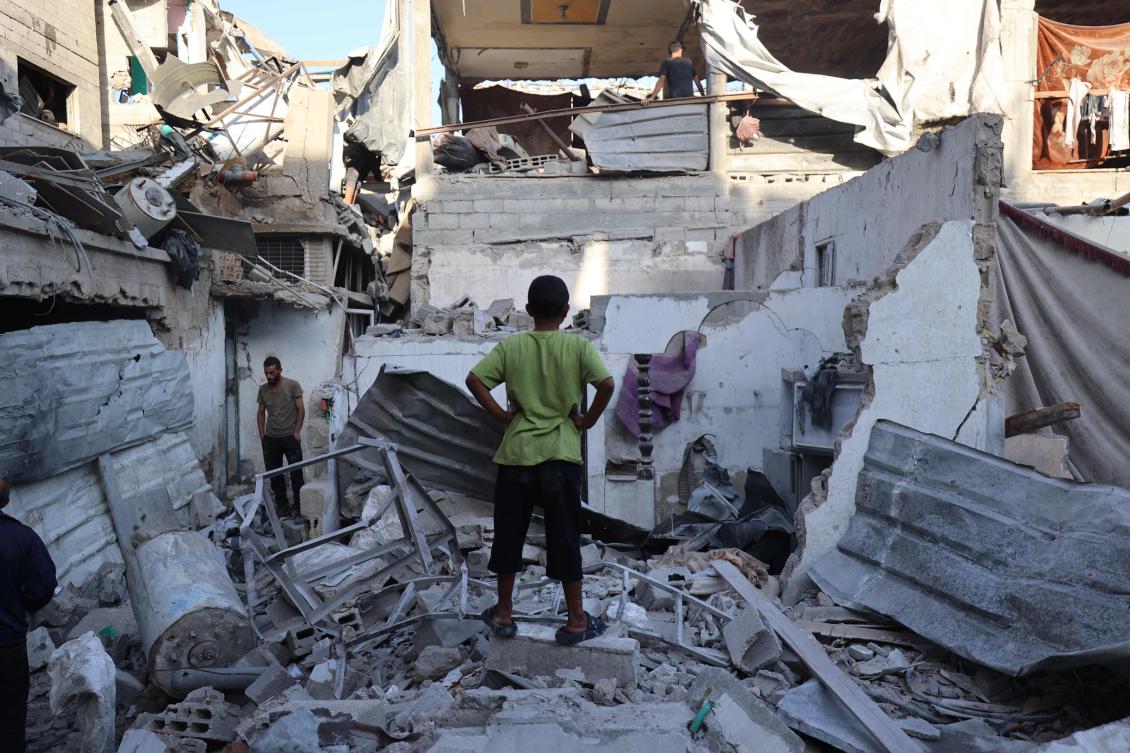 Palestinians inspect the damage around their homes after an Israeli strike targeted the previous day the Bureij refugee camp in the central Gaza Strip on Oct. 20, 2025. (AFP)