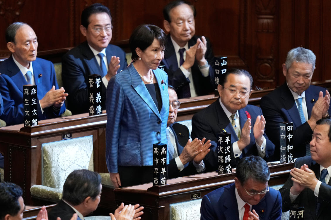 Lawmakers applaud as Sanae Takaichi, standing, was elected as Japan’s new prime minister during the extraordinary session of the lower house in Tokyo on Oct. 21, 2025. (AP)