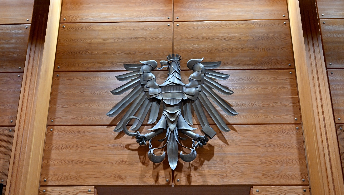 The coat of arms of the Republic of Austria, a single-headed eagle, is pictured at a courtroom at the Regional court of Innsbruck, Austria. (AFP)