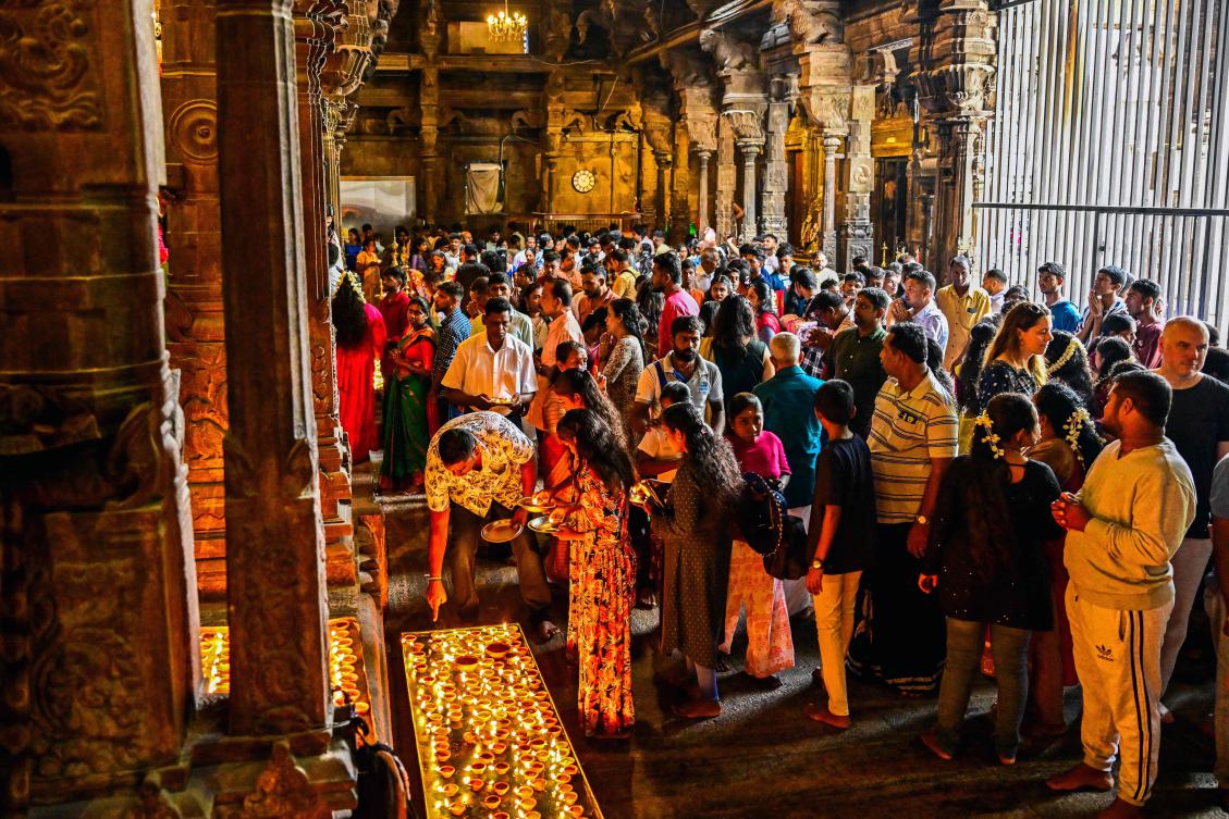 Devotees offer prayers on the occasion of 'Diwali', the Hindu festival of lights at a temple in Colombo on October 20, 2025. (Photo by Ishara S. KODIKARA / AFP)
