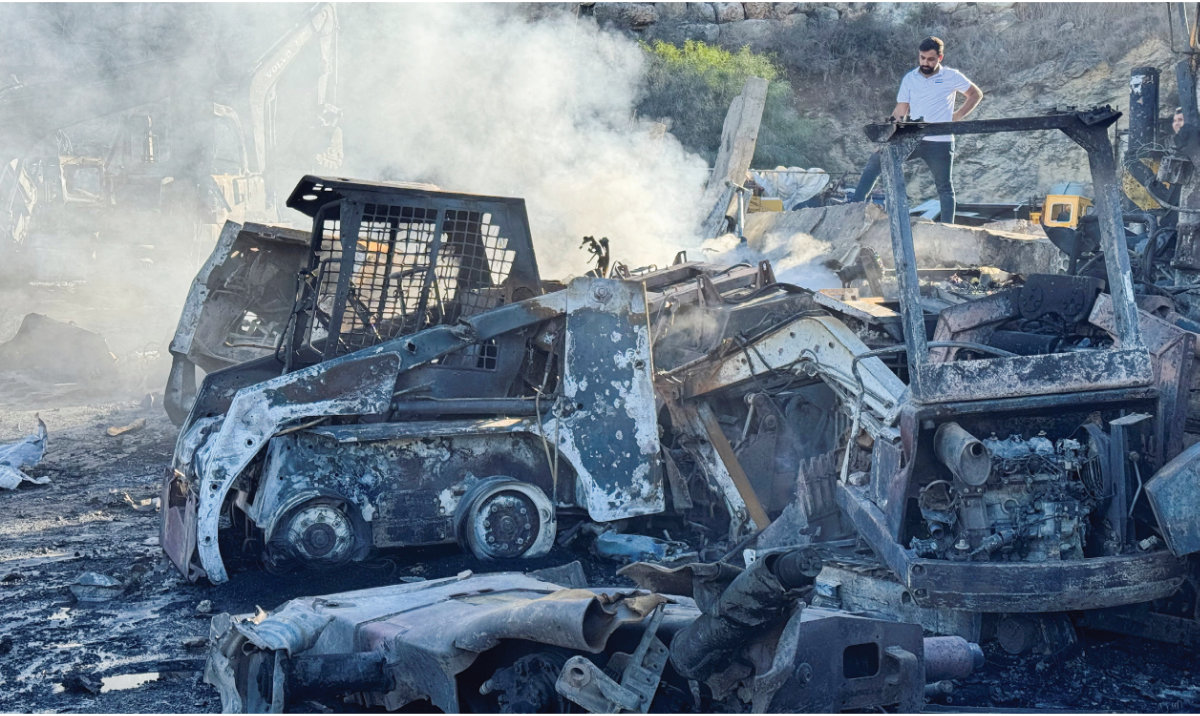 A man stands at a damaged site that sold heavy machinery in the aftermath of Israeli airstrikes, in the southern village of Msayleh, Lebanon, on October 11, 2025. (Reuters)