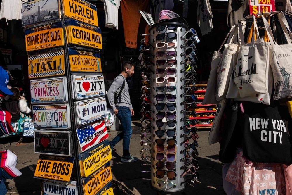 People walk along Canal Street in Manhattan the morning after numerous vendors were arrested in a raid by federal agents from Immigration and Customs Enforcement (ICE) on October 22, 2025 in New York City. (Getty Images/AFP)