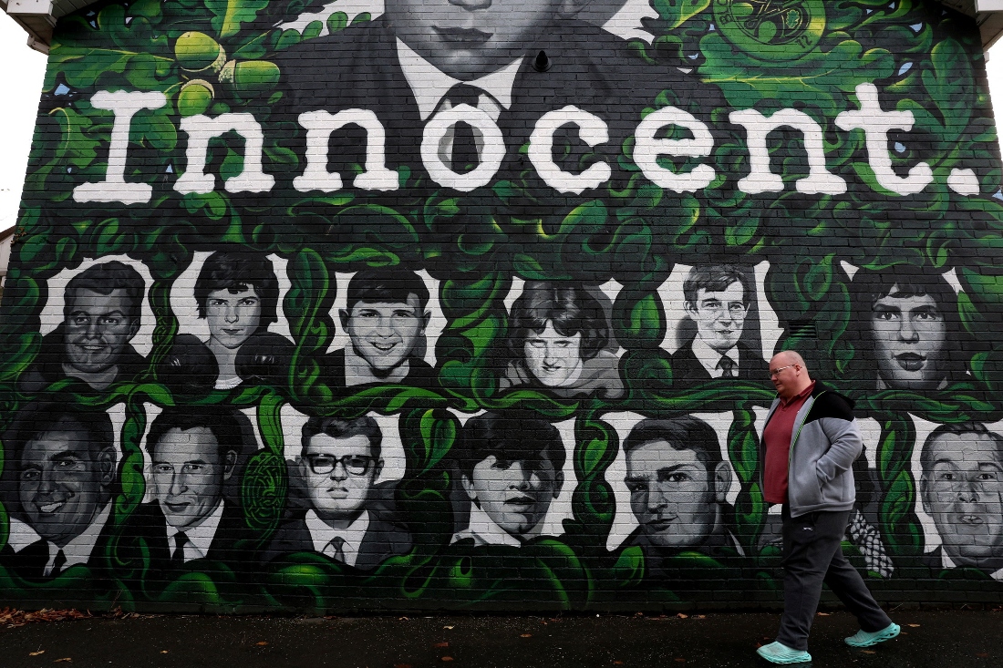 A person walks past a mural depicting the victims of the Bloody Sunday killings in Londonderry, Northern Ireland. (Reuters)