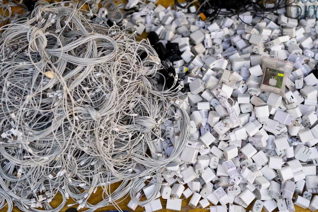 Used charging cables and power adapters are piled up at a shop in Nhat Tao market, the largest informal recycling market in Ho Chi Minh City, Vietnam. (AP)