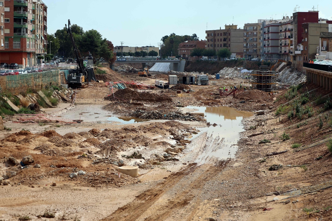 Workers install structures and enormous stones in the dry artificial channel of Paiporta,, Spain. (AFP)