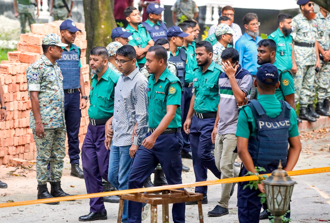 Police personnel escort detained army officers to the International Crimes Tribunal (ICT) court in Dhaka, Bangladesh. (AFP)