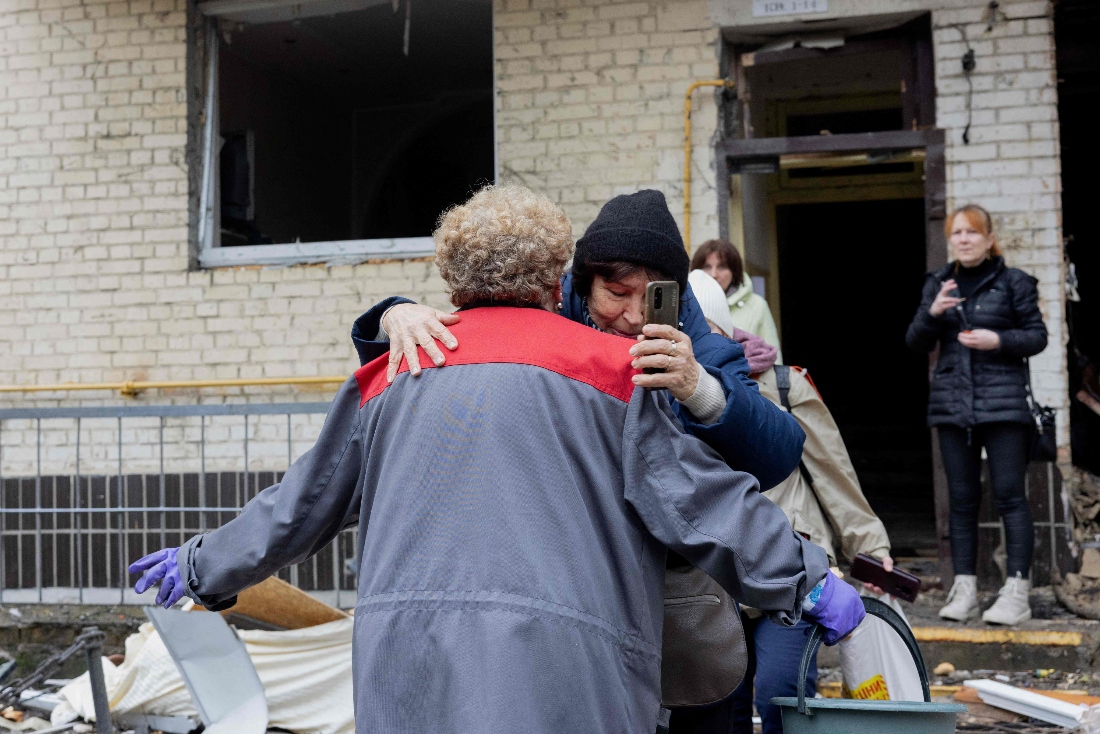 Women hug near a damaged residential building following a drone attack in Kyiv, Ukraine. (AFP)