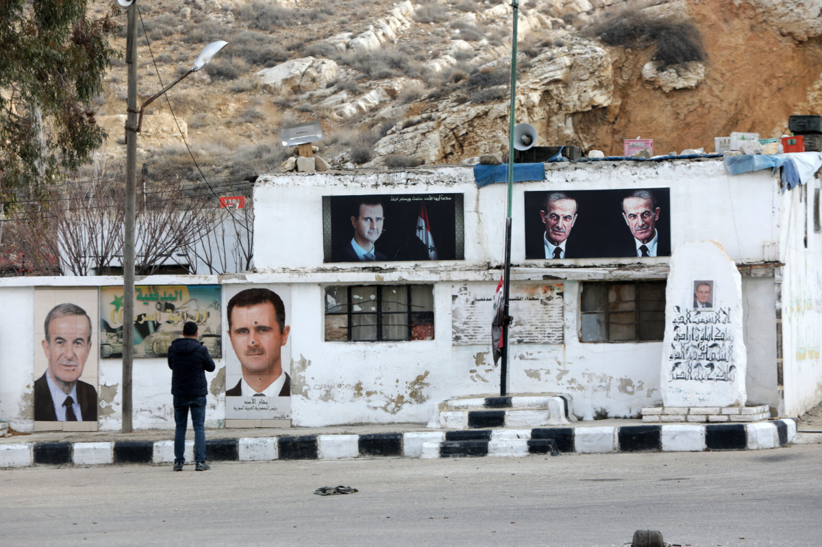 Posters of Syria's ousted president Bashar al-Assad and his late father and former president Hafez al-Assad are seen on a wall inside the abandoned Syrian Republican Guard (SRG) base on Mount Qasyun overlooking Damascus on January 4, 2025. (AFP)
