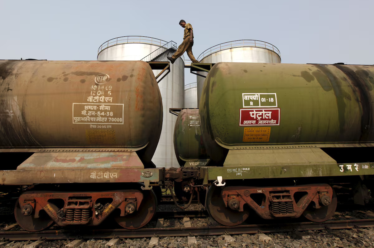 In this file photo, a worker walks atop a tanker wagon to check the freight level at an oil terminal on the outskirts of Kolkata, India on Nov. 27, 2013. (Reuters)