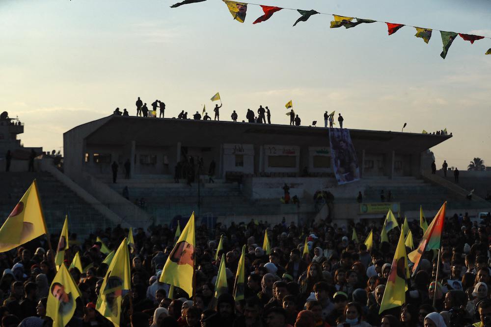 Supporters wave flags bearing pictures of the founder of the Kurdistan Workers’ Party (PKK) Abdullah Ocalan, as they gather in Qamishli in northeastern Syria to listen to a message from the jailed leader on Feb. 27, 2025. (AFP)