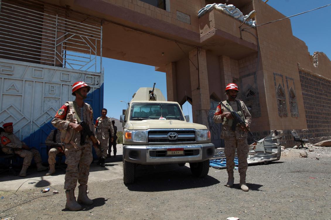 Military police stand guard outside the entrance of the central prison of Omran, north of Yemen on June 9, 2014 after Houthi rebels stormed the building the day before and aided in the escape of over 400 prisoners. (FILE/AFP)