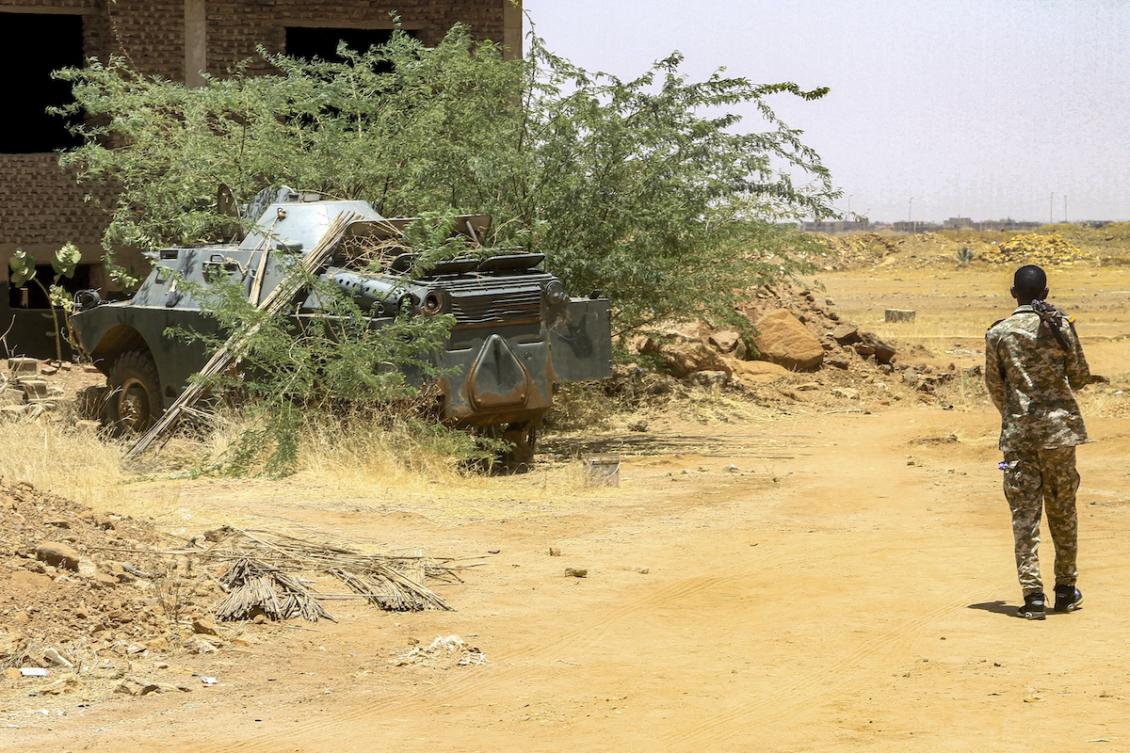 A Sudanese army soldier walks near an armoured vehicle seized after their capture of a base used by the rival Rapid Support Forces (RSF) paramilitaries after the latter group evacuated from the Salha area of Omdurman, the twin-city of Sudan's capital, on May 26, 2025. (FILE/AFP)