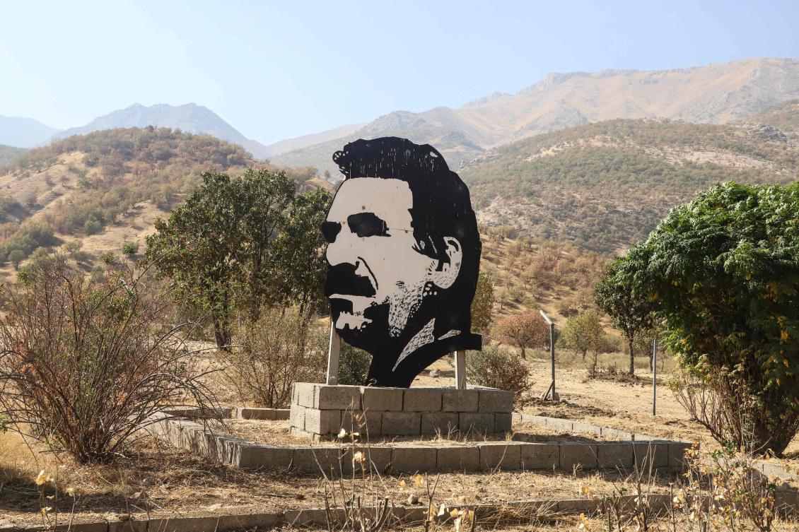 This photograph shows a cutout portrait of jailed leader of the Kurdistan Workers’ Party (PKK), Abdullah Ocalan, during a ceremony in the Qandil area of northern Iraq, where the militant group announced its complete withdrawal of forces from Turkiye, Oct. 26, 2025. (Shwan MOHAMMED / AFP)
