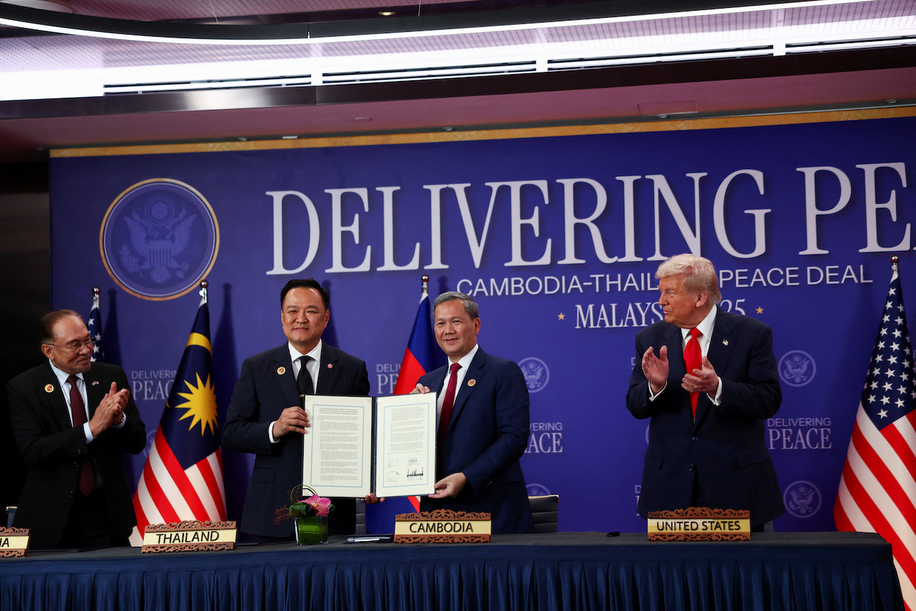 Malaysia’s PM Anwar Ibrahim and US President Donald Trump applaud as Thailand’s PM Anutin Charnvirakul and Cambodia’s PM Hun Manet hold up a document, during the signing of a ceasefire deal, October 26, 2025. (Reuters)