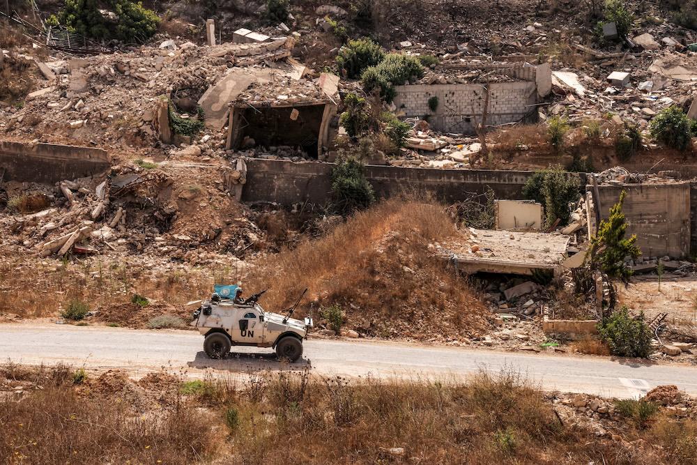 Above, an armored vehicle of the United Nations Interim Force in Lebanon (UNIFIL) moves past destroyed buildings along a road in the village of Kfar Kila in southern Lebanon on Aug. 27, 2025. (AFP)