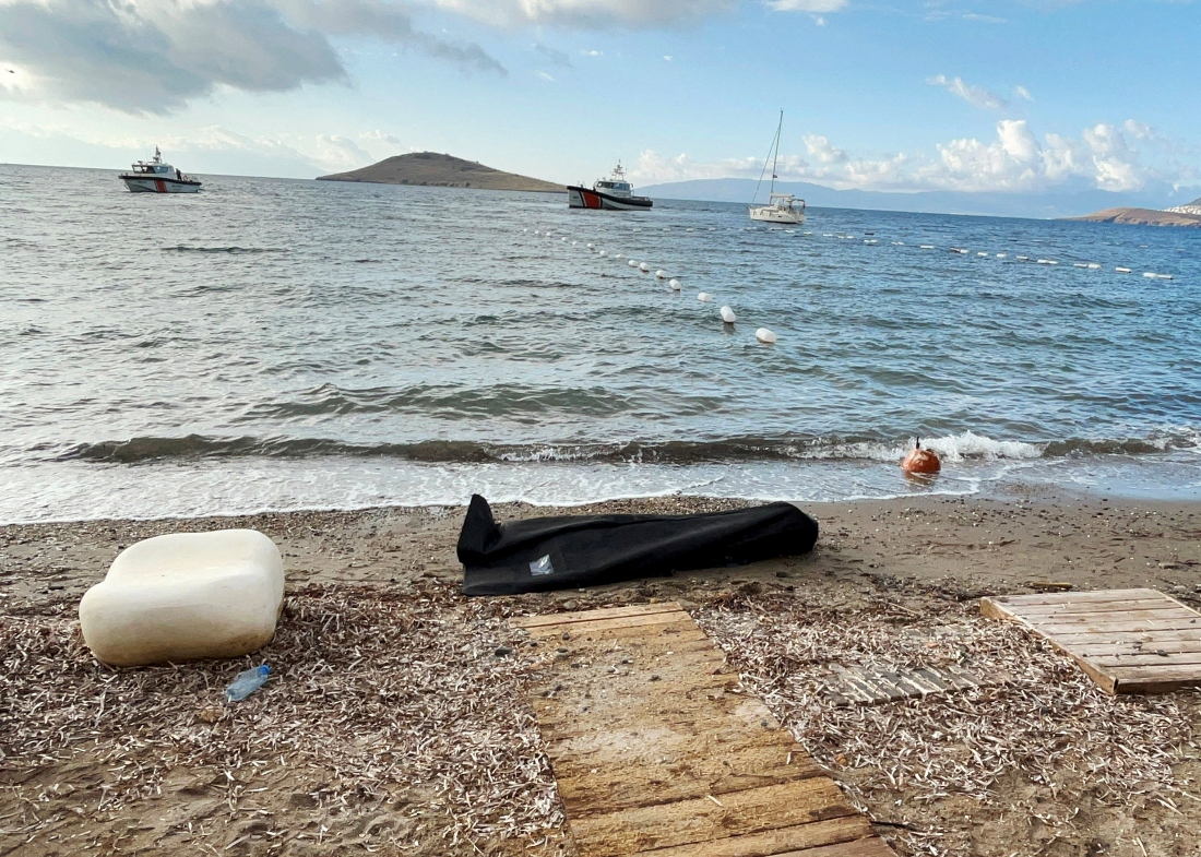 A body bag lies on the shore as Coast Guard Command members conduct a search and rescue operation following the sinking of a migrant boat off western Mugla province, Turkiye. (Reuters)