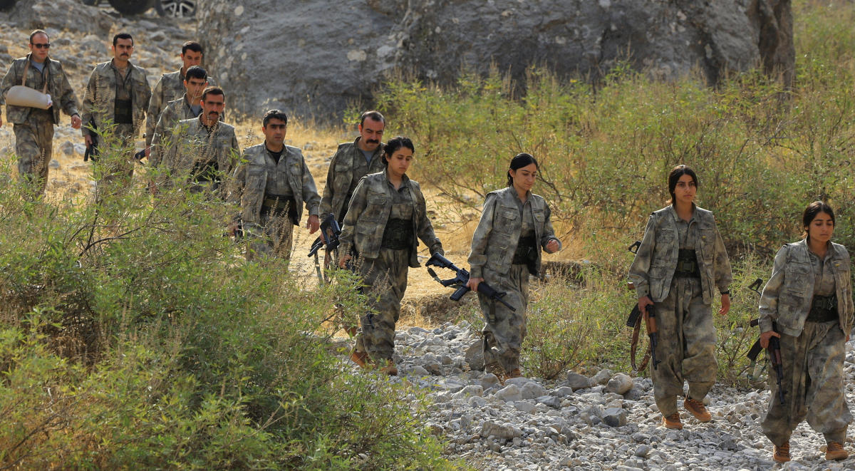 Fighters with the Kurdistan Workers' Party (PKK) walk for a disarmament ceremony in Iraq on Sunday marking a significant step toward ending the decades-long conflict with Turkiye's government. (Reuters)