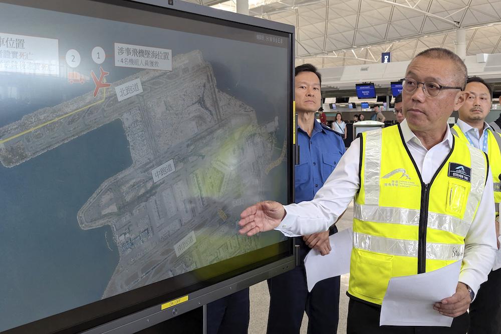 Steven Yiu, Airport Authority Hong Kong’s executive director of airport operations, shows the location where a Boeing 747-400 cargo aircraft skidded into the sea during landing on the north runway of Hong Kong’s international airport on Oct. 20, 2025. (AFP)
