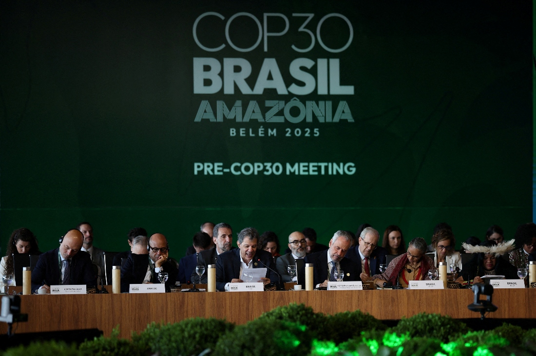 Brazil's Finance Minister Fernando Haddad speaks next to Simon Stiell, Executive Secretary of UN Climate Change (UNFCCC), and Brazil's COP30 President Andre Correa do Lago during the ministerial preparatory meeting (Pre-COP30), ahead of the COP30 Climate Summit, in Brasilia, Brazil. (Reuters)