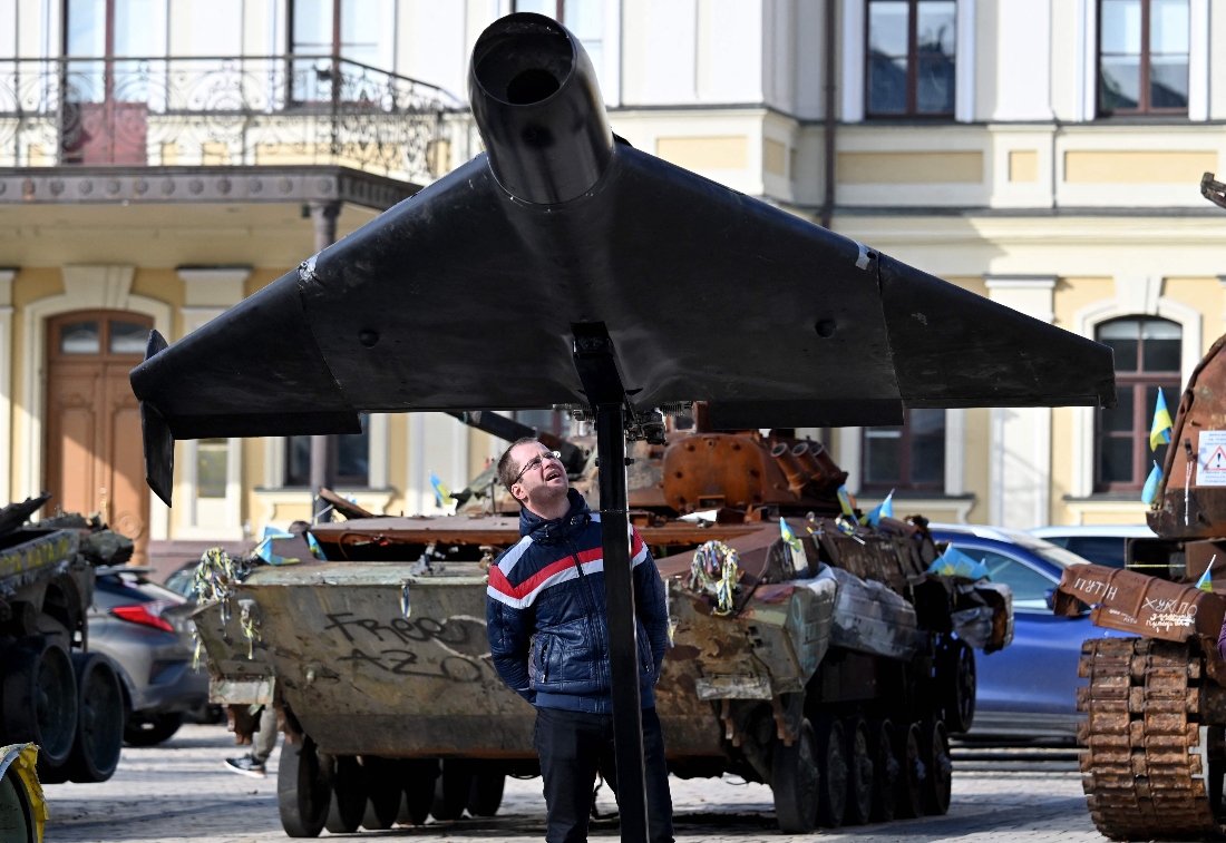A man examines Russia Iranian drone a Shahed 136 (Geranium-2), a new exhibit of open air exhibition destroyed Russian equipment in Kyiv, Ukraine. (AFP)