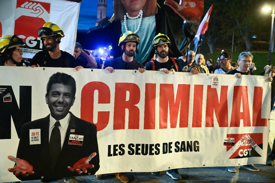 Demonstrators hold up banners during a march to mark the first anniversary of last year's deadly floods and demand accountability in Valencia, Spain. (AFP)