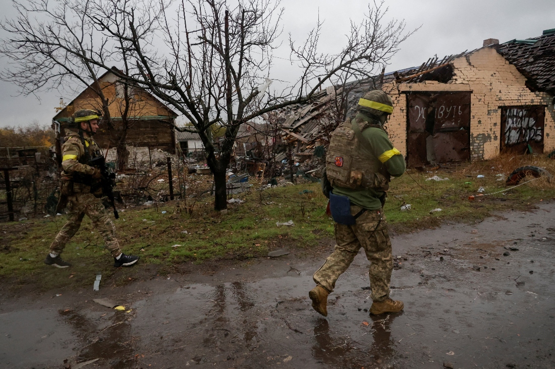 Servicemen of the 115th Separate Mechanized Brigade of the Ukrainian Armed Forces walk along a street, amid Russia's attack on Ukraine, in the frontline town of Lyman in Donetsk region, Ukraine. (Reuters)