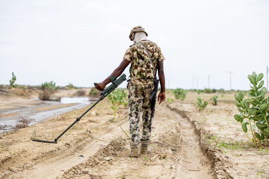 A Nigerian soldier from the Multinational Joint Task Force (MNJTF) uses a metal detector to search for IEDs in Monguno, Borno state, Nigeria. (AFP)